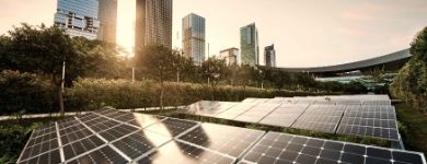 large panel of solar cells with buildings in background